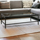 54" Clear And Black Glass And Steel Coffee Table With Shelf